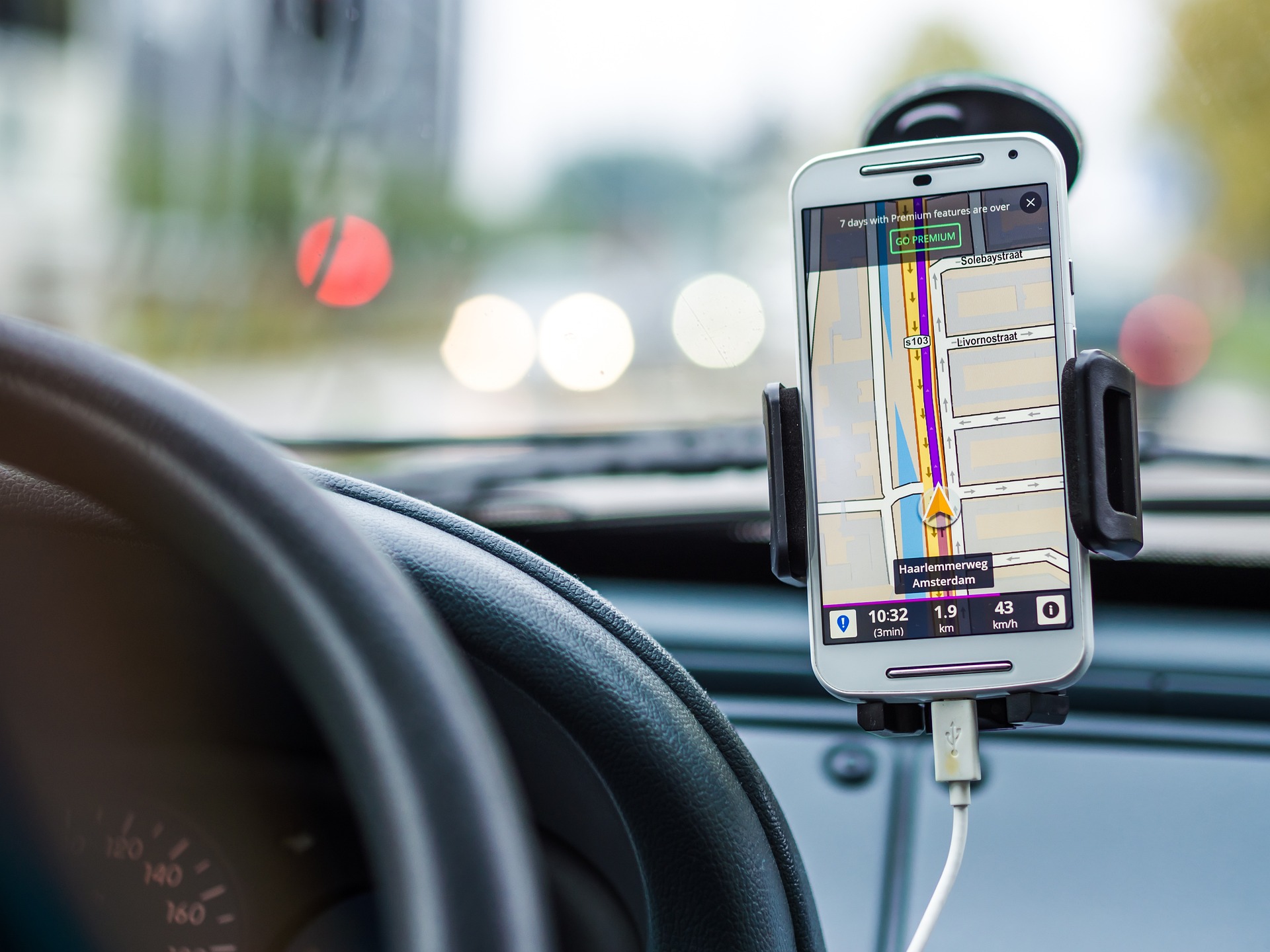 car interior dashboard with route display on mounted smartphone