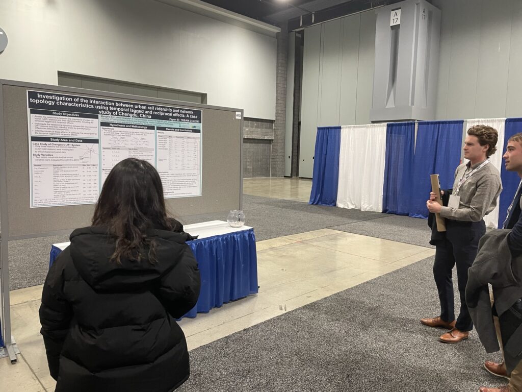 Research poster and onlookers at TRB 2023